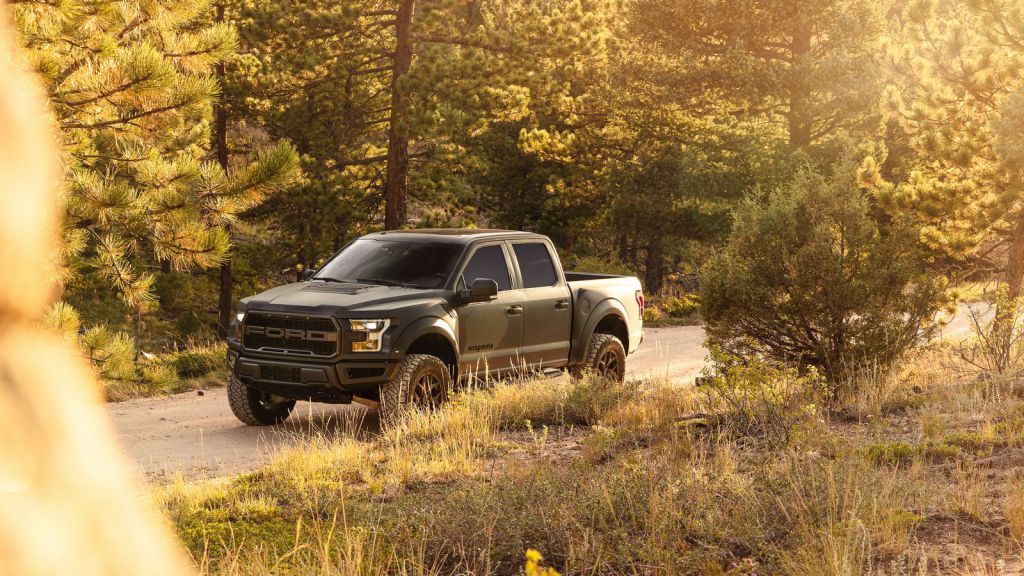 Ford Raptor Camo Truck Wrap Driving on Dirt Trail - Wrapmate