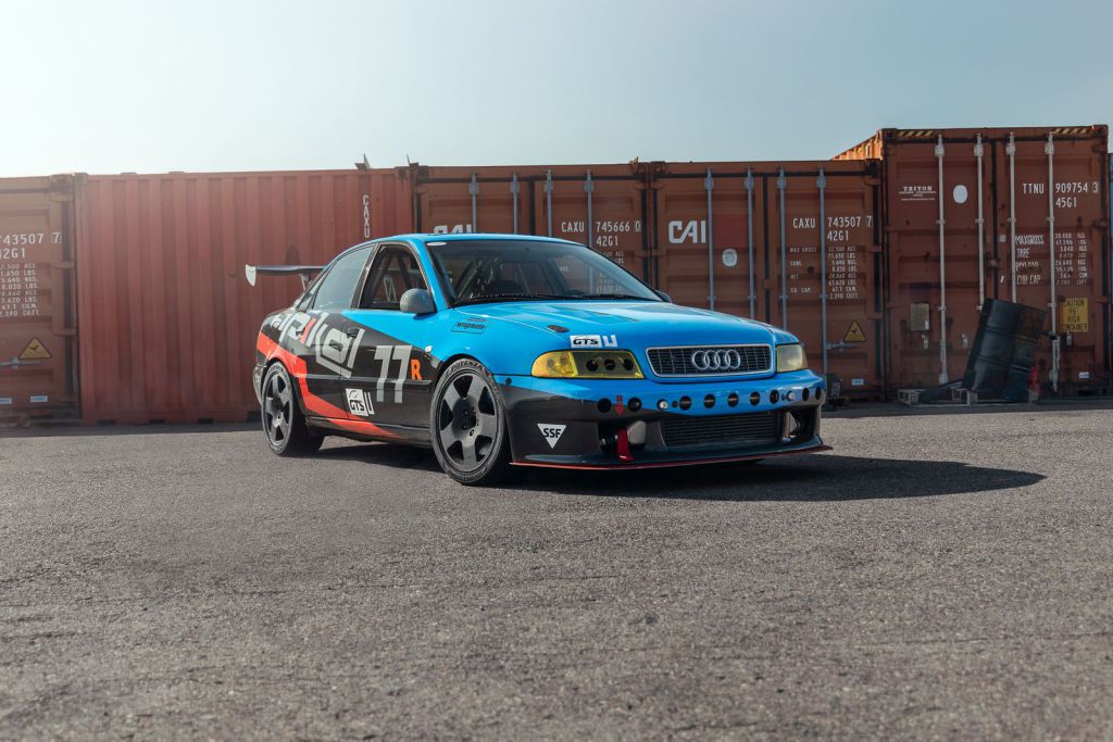 Apikol Performance Race Car Wrap in front of shipping containers - by Wrapmate