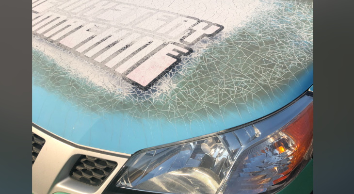 Graphics showing many cracks & tears across hood of vehicle