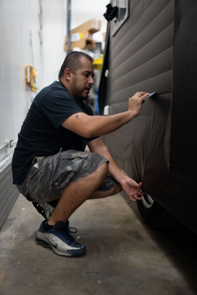 Wrapmate Pro Installer wrapping a travel trailer wrap for Tap Trailer Co